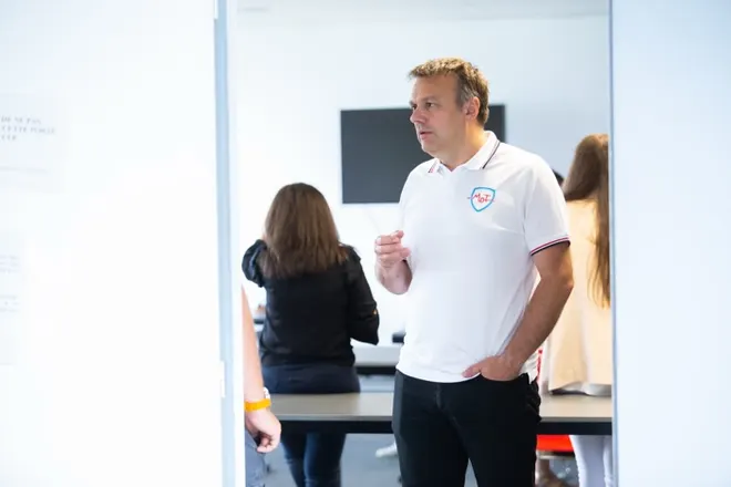 A MyData-TRUST manager talking with colleagues in a meeting room