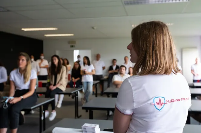 A MyData-TRUST colleague attending a team presentation in a training room