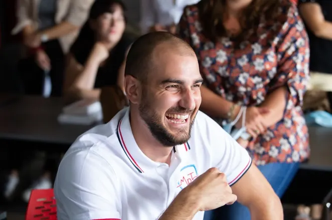 A MyData-TRUST colleague laughing during a team event